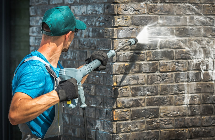 worker spraying the wall